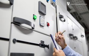 Engineer inspecting control panel for UPS system maintenance