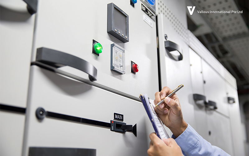 Engineer inspecting control panel for UPS system maintenance