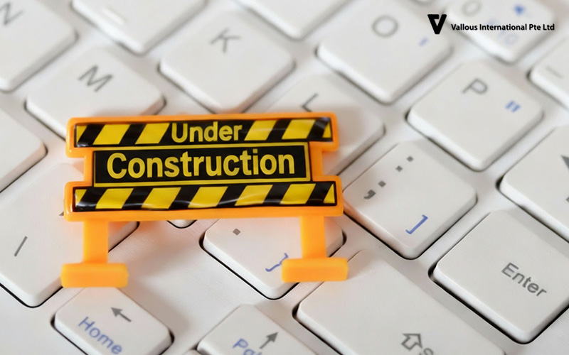 Vallous International Under Construction sign on a laptop keyboard.