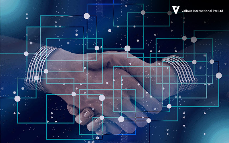 Vallous International handshake over a digital network grid.