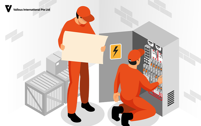 Vallous International technicians performing maintenance on an electrical panel.
